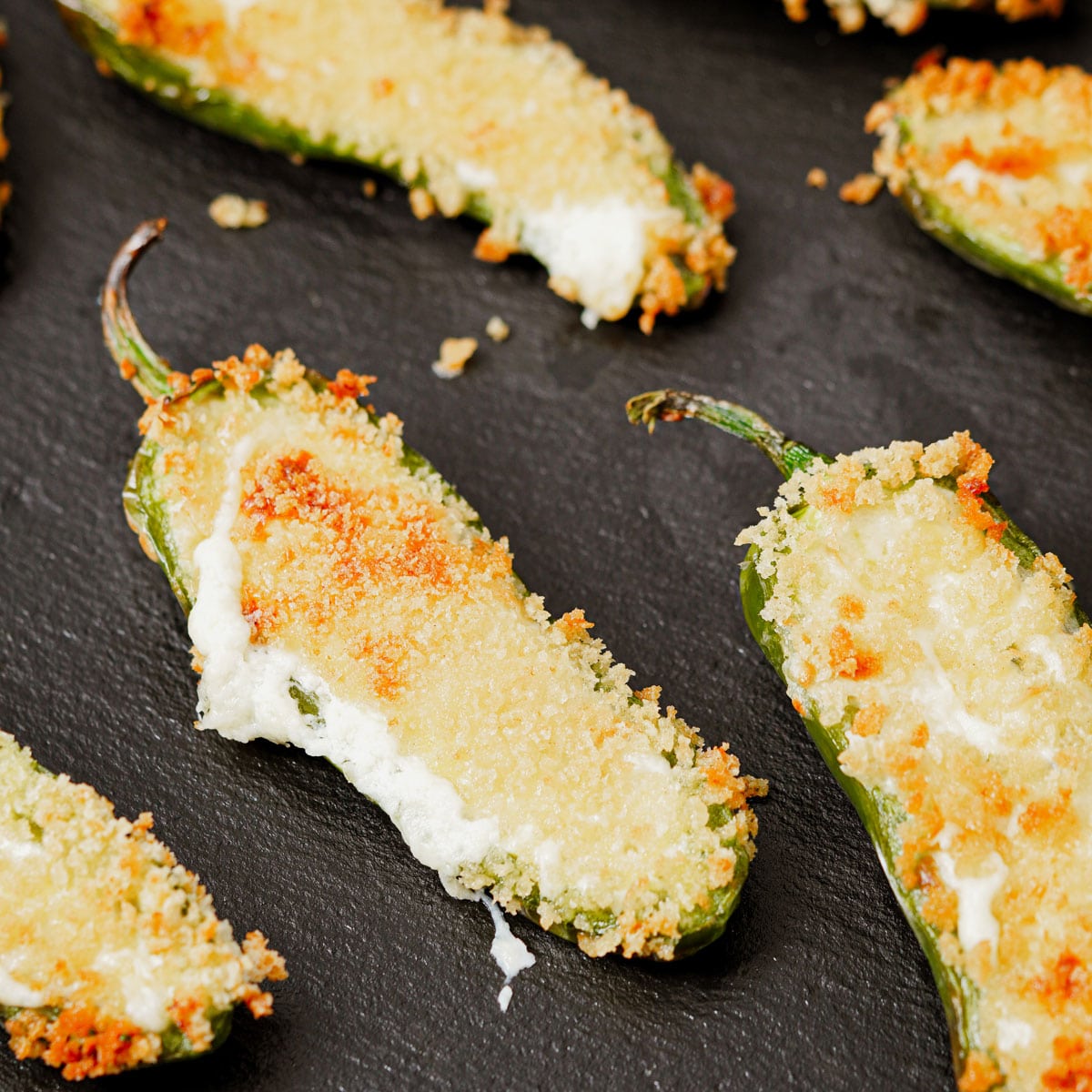 Air fried jalapeno poppers served in a black slate