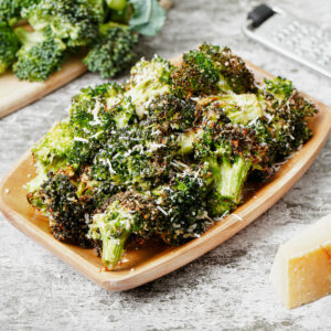 Air fryer broccoli parmesan served in a wooden tray.