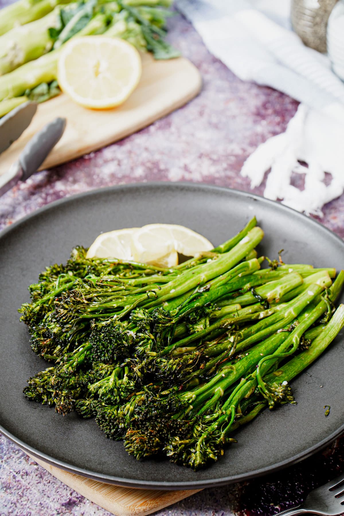 Roasted air fryer broccolini recipe bite shot, with lemon wedges