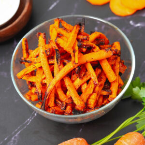 Air fryer carrot fries served in a medium glass bowl