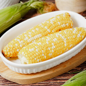 Air fryer corn on the cob served in a small baking dish.