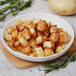 Air fryer diced potatoes served in a white plate