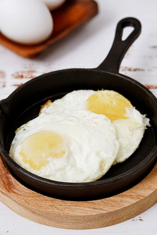 Air fryer eggs recipe bite shot, served in a small cast iron skillet