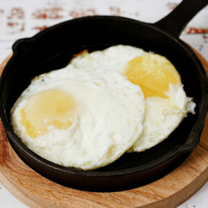 Air fryer eggs in a small cast iron skillet