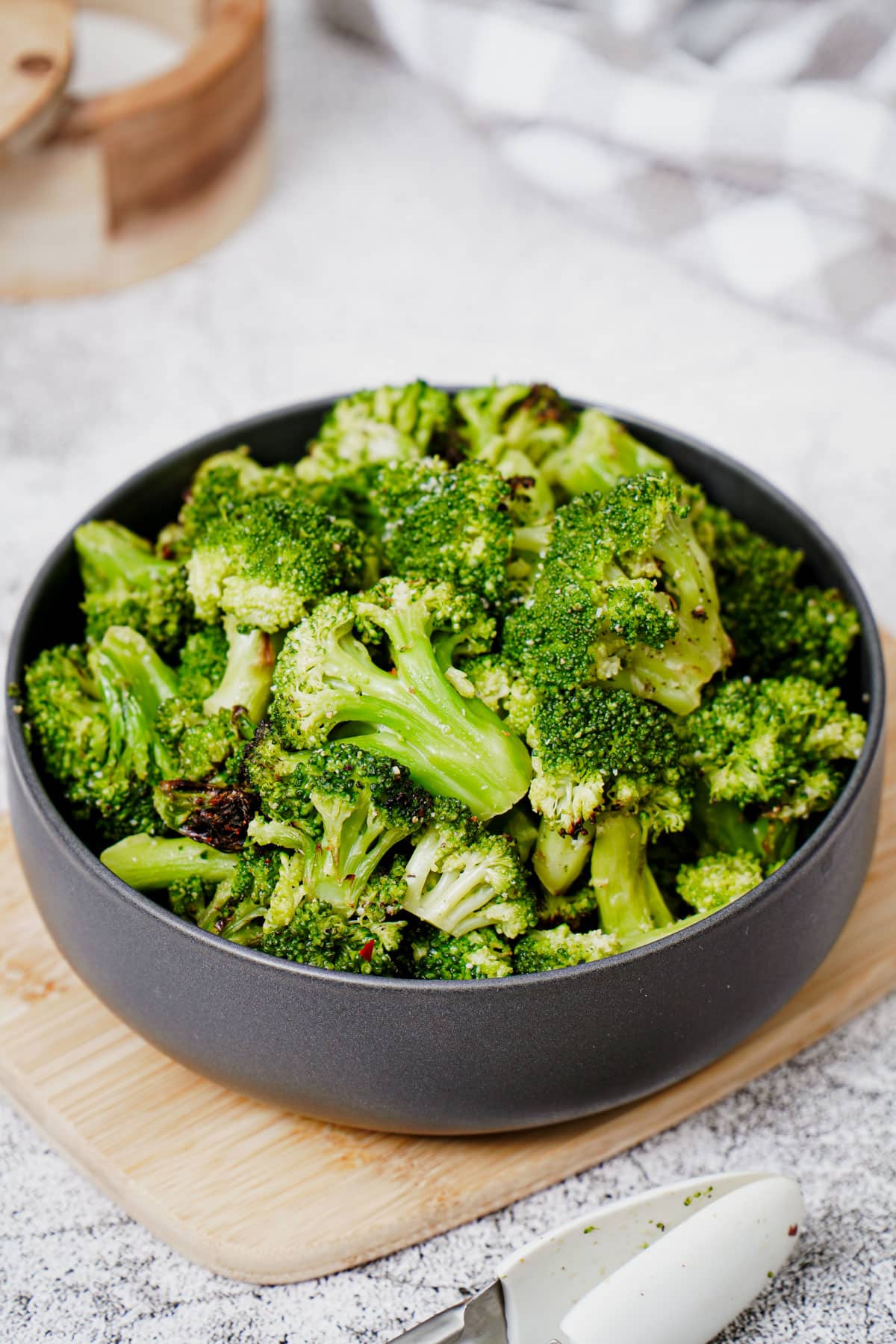 Air fryer frozen broccoli recipe bite shot served in a black bowl.