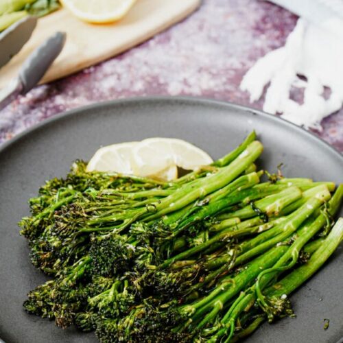 Roasted air fryer broccolini recipe bite shot, with lemon wedges