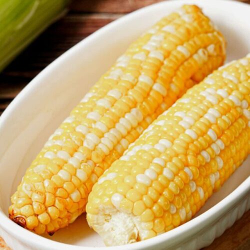Air fryer corn on the cob recipe bite shot, served in a small baking dish.