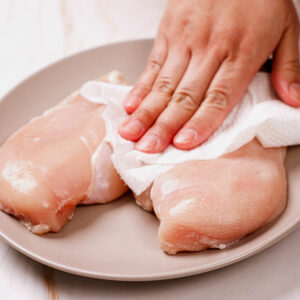 Patting chicken breasts dry