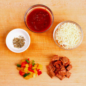 Pizza Toppings: Pizza sauce, mozzarella cheese, pepperoni slices, bell pepper, and Italian seasoning.