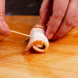 Securing bacon-wrapped date with toothpick