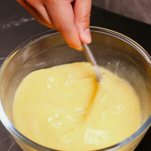 Whisking eggs in a medium mixing bowl