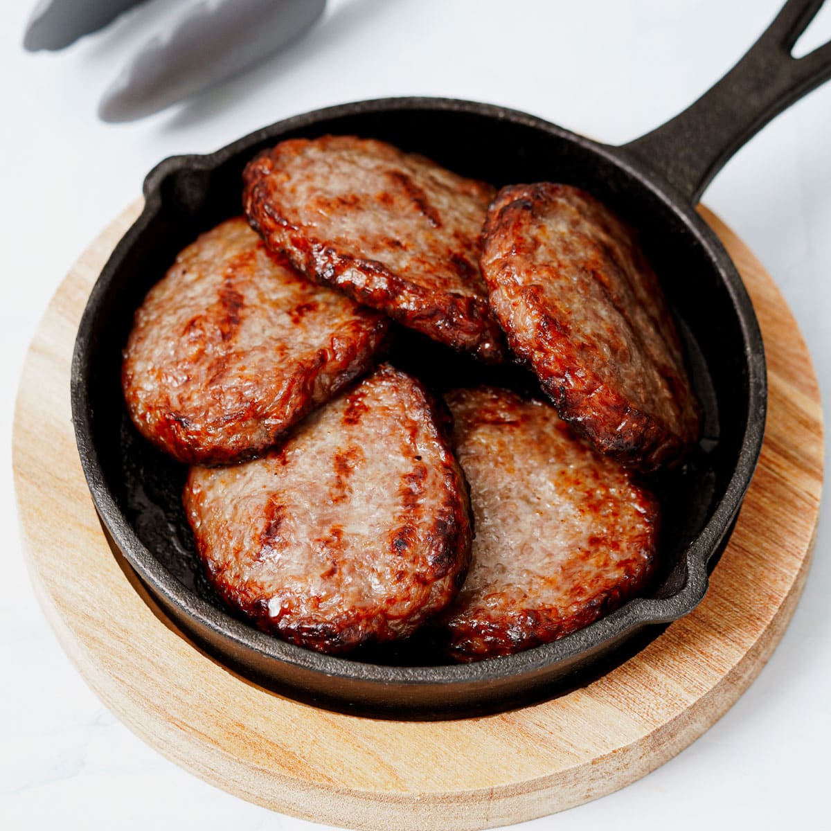 Air fried breakfast sausage patties in a mini cast iron pan