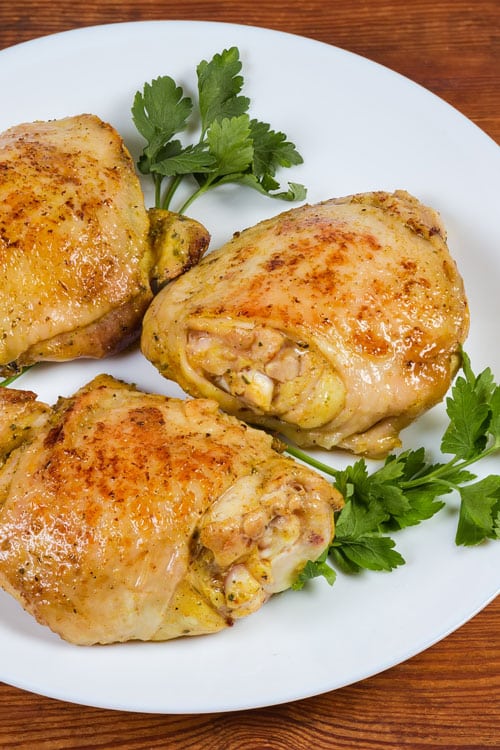 Air fryer bone-in chicken thighs, recipe bite-shot, served with parsley