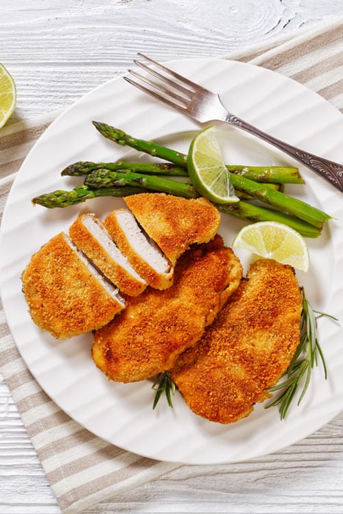 air fryer breaded chicken breast bite shot, with asparagus on the side