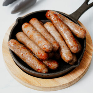 Air fryer breakfast sausage links in a mini cast iron pan