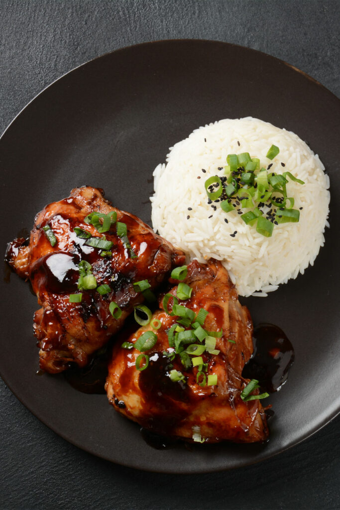 Air fryer marinated chicken thighs, recipe bite-shot, with rice on the side