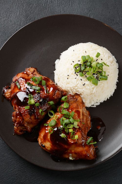 Air fryer marinated chicken thighs, recipe bite-shot, with rice on the side