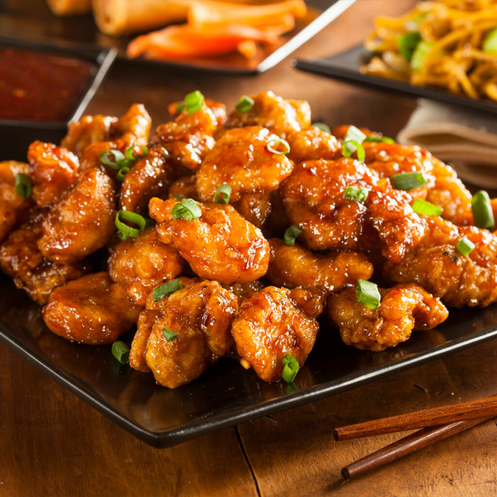 air fried orange chicken, served with garnished with chopped scallions
