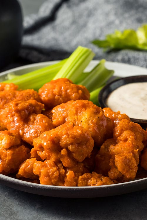 Buffalo chicken nuggets air fryer, recipe bite-shot, served with ranch and celery sticks