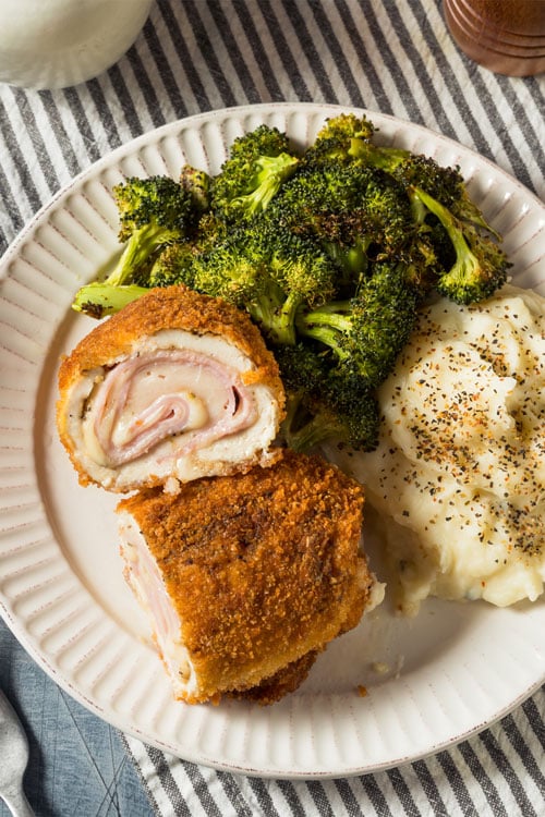 chicken cordon bleu air fryer, recipe bite-shot, with broccoli and mashed potato on the side
