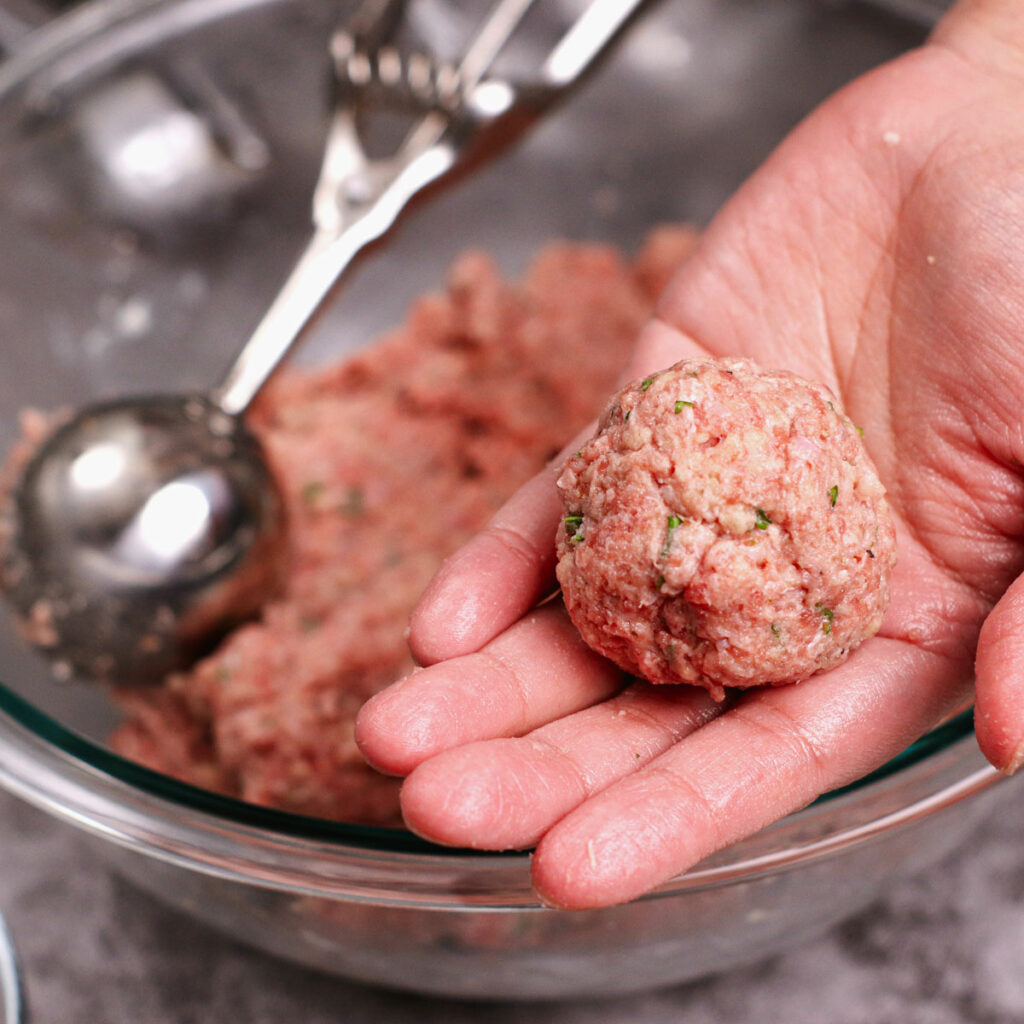 Perfectly rolled meatball on hand