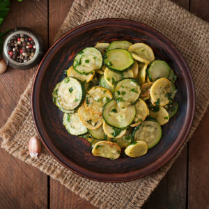 Air fryer zucchini and squash, served on a brown plate