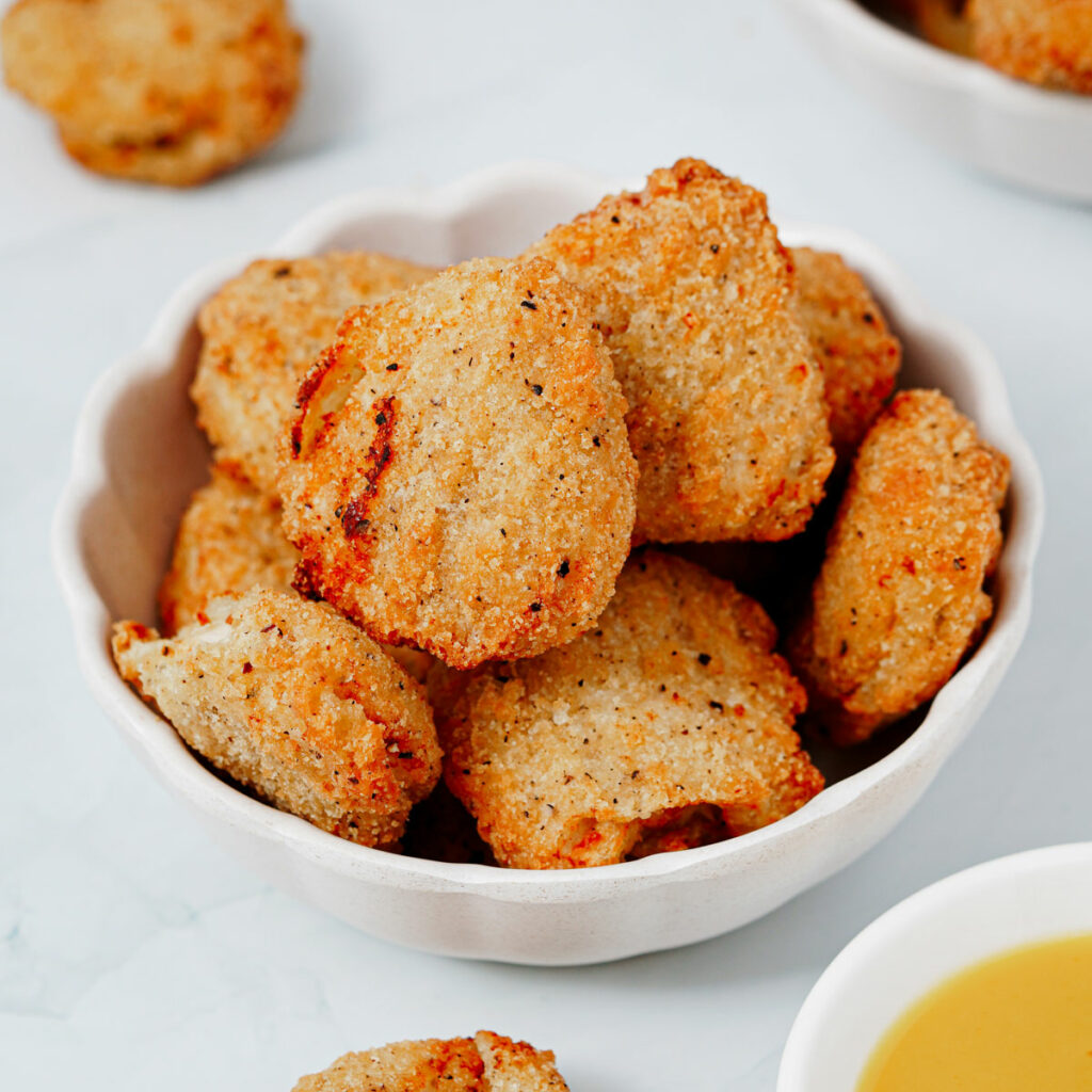 Air fryer frozen chicken nuggets served in a small bowl