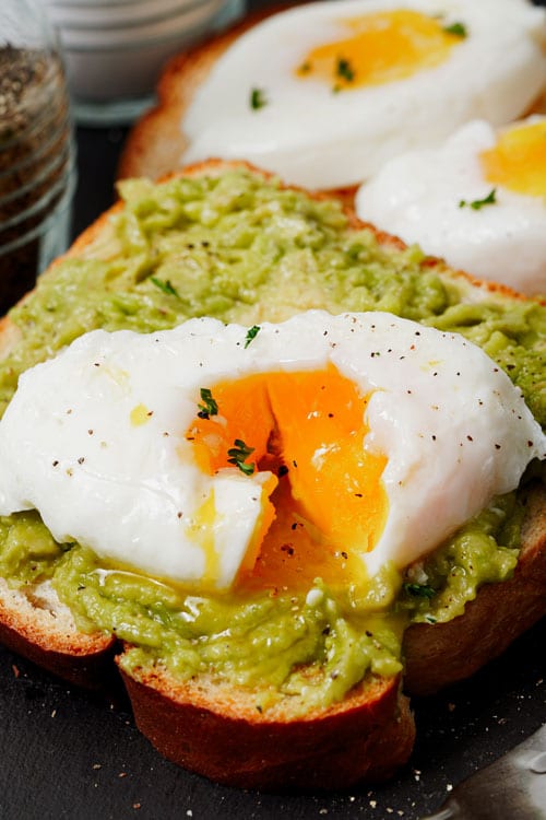 Air fryer poached eggs recipe bite shot, served on top of avocado toast
