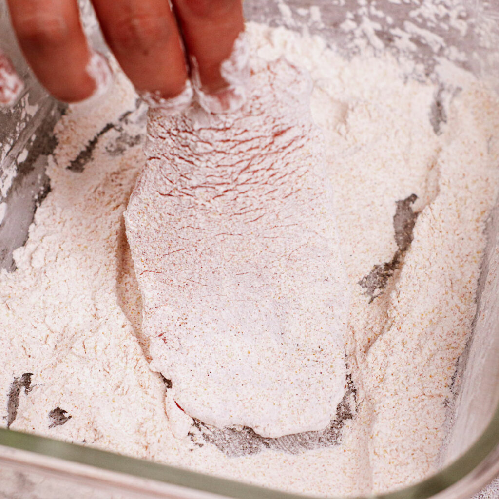 Step 1: Dredge the tenderized pork cutlet in the cornstarch mixture.