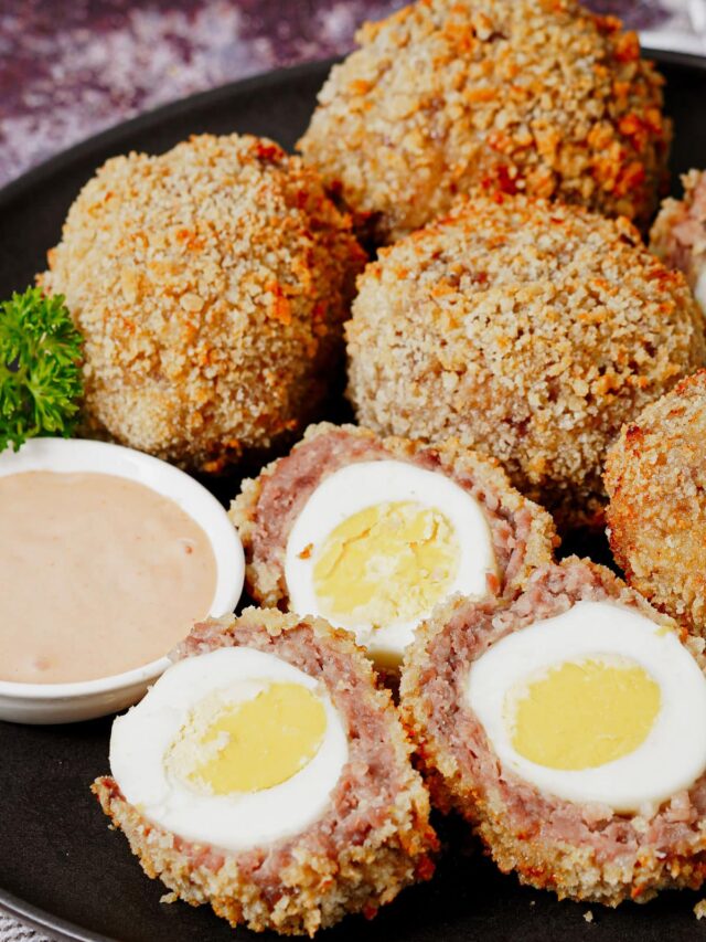 Air fryer scotch eggs recipe bite shot, served with fry sauce.