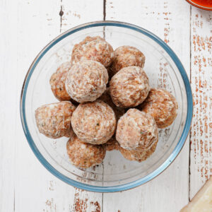 Frozen meatballs in a glass mixing bowl