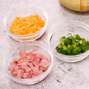 Filling for mini quiche recipe: shredded cheddar, sliced ham, green onion